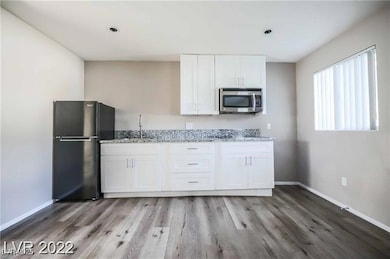 Kitchen featuring stainless steel microwave, frees