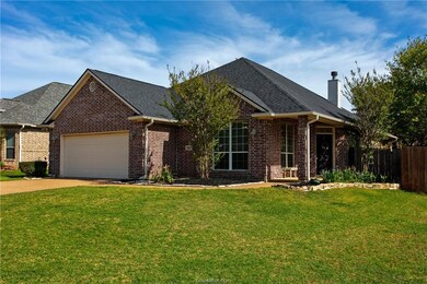 Ranch-style house featuring a garage, a front lawn