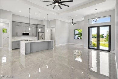 Kitchen featuring gray cabinetry, a high ceiling,