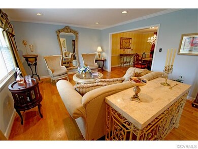 Living Room offers crown molding, oak flooring, an