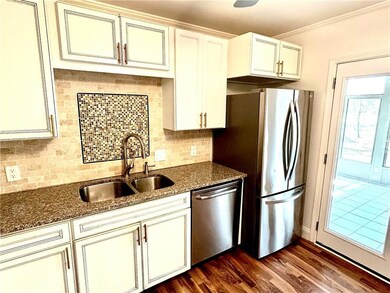 Kitchen featuring sink, dark stone countertops, ap