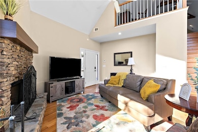 Living room with high vaulted ceiling, hardwood / 
