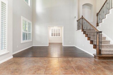 Entryway with wood-type flooring and a high ceilin