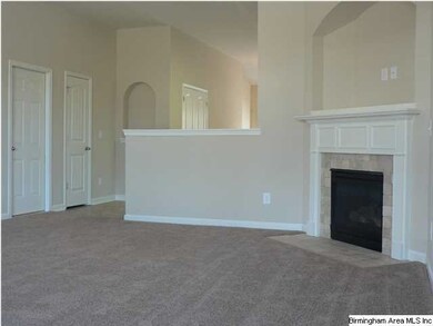 Great room with vaulted ceilings and a fireplace w