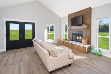 Living room with high vaulted ceiling, french door