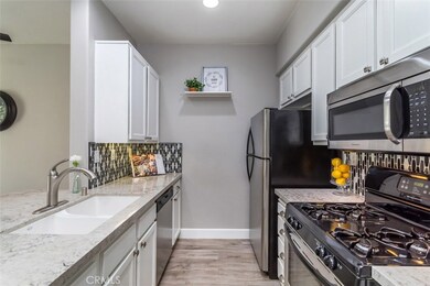 Upgraded kitchen with quartz counters and custom backsplash