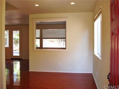 FRESHLY PAINTED LIVING ROOM WITH LAMINATE FLOORING