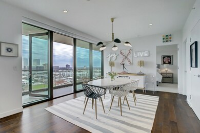 FORMAL DINING ROOM OPENS TO THE LARGE BALCONY WITH PANORAMIC VIEWS OF HOUSTON