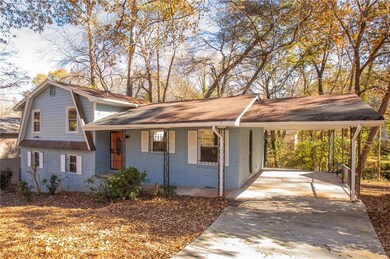 View of front of home with a porch and a carport