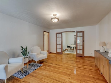 Sitting room featuring french doors and light wood-style floors
