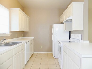 Kitchen with refrigerator, dish washer, stove, and