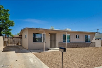Single story home featuring a gate, concrete block