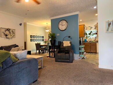 Living room featuring a textured ceiling, crown mo