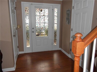 Foyer with dark wood-style flooring, plenty of nat