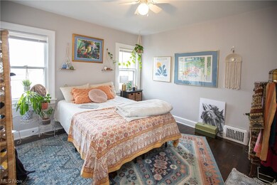 Bedroom featuring ceiling fan and dark hardwood / wood-style floors