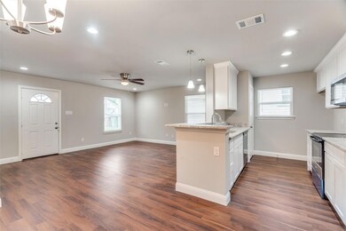 Kitchen featuring baseboards, a peninsula, visible