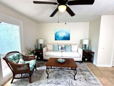 Living room featuring tile flooring and ceiling fa