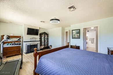 Bedroom featuring light wood finished floors, a fi