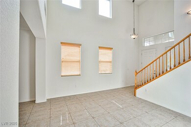 Unfurnished living room featuring a towering ceili