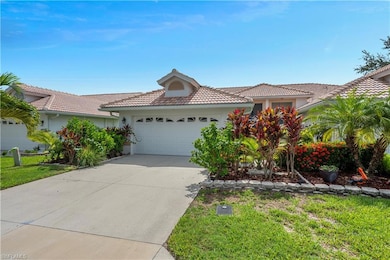 View of front of home with tiled roof, attached 2 car garage