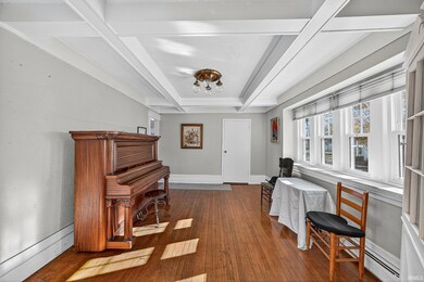 Formal Dining room featuring beam ceiling, dark wood finished floors, and coffered ceiling