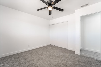 Unfurnished bedroom with a ceiling fan, baseboards
