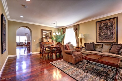 Living room with arched walkways, plenty of natura
