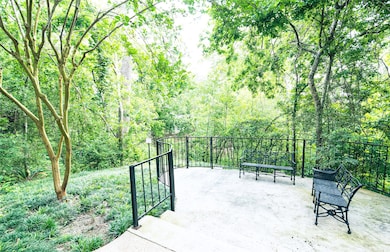 Serene Outdoor Space by the Bayou.
As you walk around the building to the entrance of the condo, you'll be greeted by a beautiful, tranquil corner space overlooking the bayou. This serene outdoor area is the perfect spot to sit and enjoy the lush, natural landscape. Surrounded by mature trees and vibrant greenery, it offers a peaceful retreat in the heart of nature, making it an ideal place to relax or unwind.