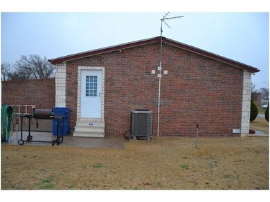 Side of house, patio to left