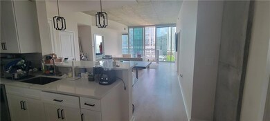 Kitchen with light wood-style flooring, a sink, li