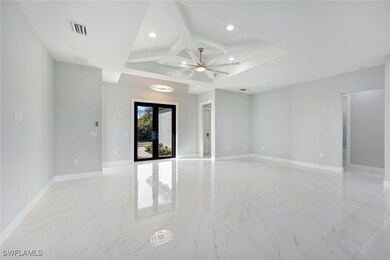 Unfurnished room with french doors, ceiling fan, a