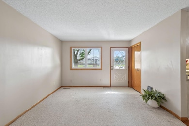 Living Room Bright and open living space with large windows bringing in natural light, neutral tones, and easy flow to the main level.