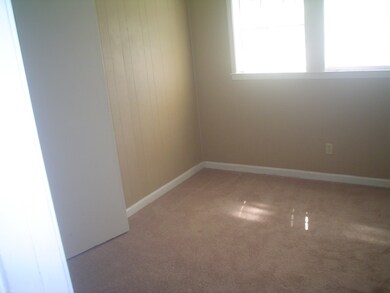 Large bedroom with carpet.