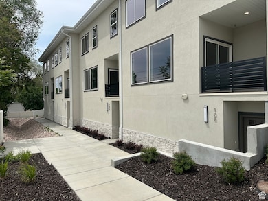 View of home's exterior with a balcony and stucco siding