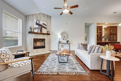 Living room with a fireplace, lofted ceiling, dar