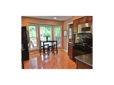 This dreamy eat in kitchen has a tile back splash,
