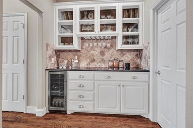 Striking butler's pantry offers granite, glass fro
