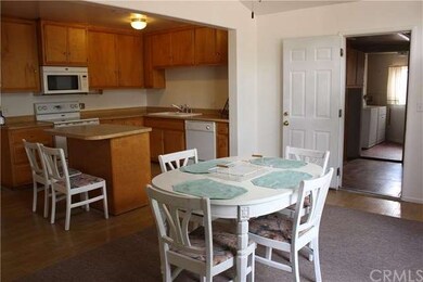 Kitchen going into laundry/utility/pantry area