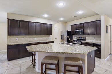 This kitchen is by far any chef’s dream! This spacious kitchen features high ceilings, dark stained wood cabinets, granite countertops, SS appliances, custom tile backsplash, recessed lighting, extended counter space, granite kitchen island with double sink and space for breakfast bar, and a walk-in pantry all overlooking your huge family room.