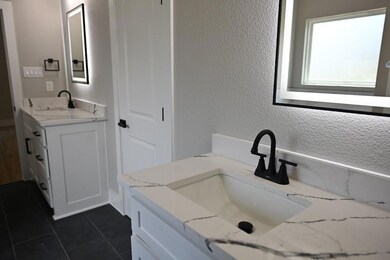 Bathroom featuring tile patterned floors and vanity