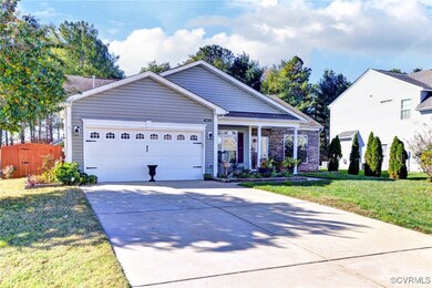 View of front of home with a garage and a front ya