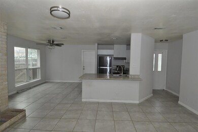 Kitchen with a sink, white cabinetry, freestandin