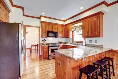 Refinished hardwood floors, breakfast bar, and pan