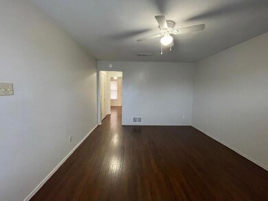 Empty room with ceiling fan and dark hardwood / wo