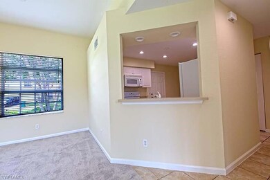 Shown is the dining room and counter top for eating.  This also shows the kitchen from the living room.