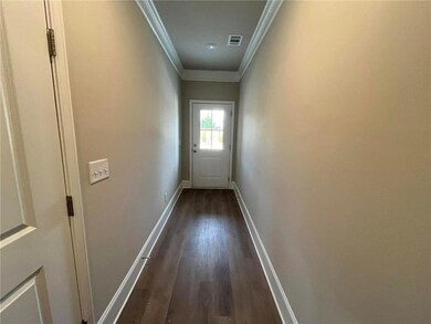 Doorway with visible vents, dark wood-style floori