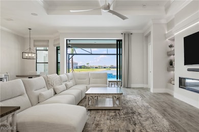 Living room with a ceiling fan, wood finished floo