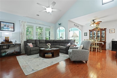 Great Room with vaulted  smooth ceiling and solar