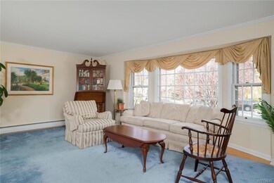 Large, airy living room with bay window.