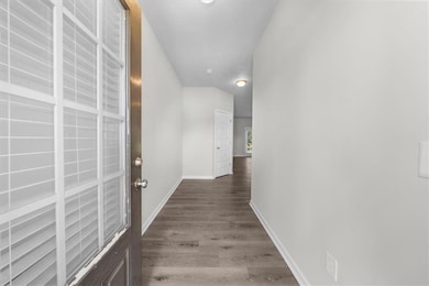 Corridor with baseboards and wood finished floors